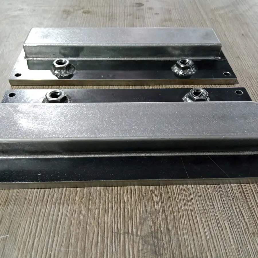 Two welded mounting plates with box section and weld nuts, drilled corner holes